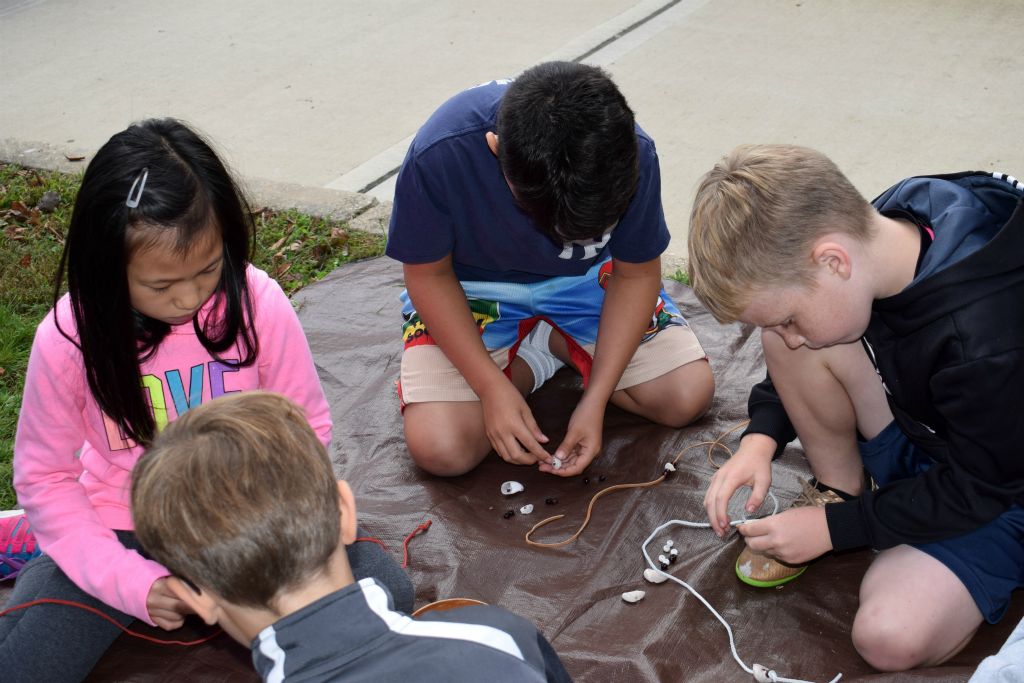 students making necklaces